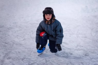 Sevimli küçük çocuk buz pistinde paten