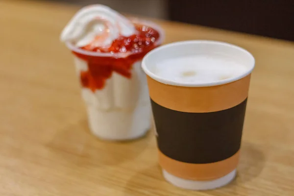 ice cream with ice cream, whipped cream and a cup of coffee