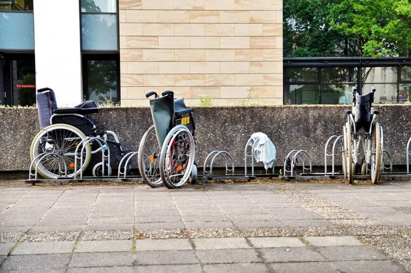 Wheelchair for the disabled parking in a hospital with old condition. Breakdown is not available. abandoned old wheelchair parking at a hospital.