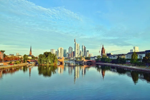 Frankfurt\'s Skyline reflecting in the Main River on sunrise. european city skyline and financial centre of Frankfurt. Germany Skyscraper buildings on blue sky background. Business and finance concept