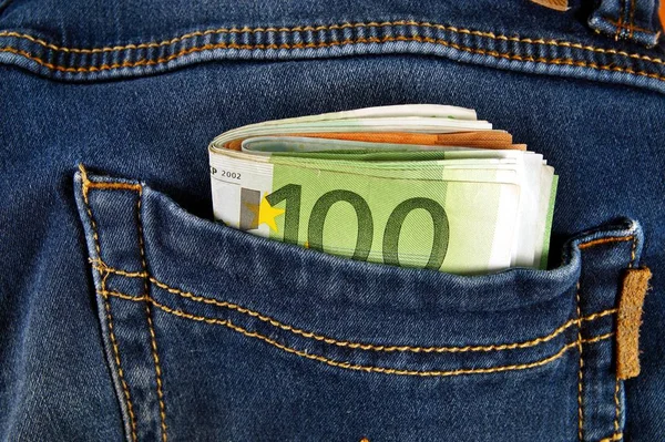 euro money cash, euro banknotes in the pockets of jeans trousers.banner for web, gift card, postcard. Concept of wealth, saving or spending money. Euro bills falling out. Easy to steal the money.