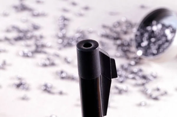 Air rifle barrel and a selection of pellets. Close up of a air gun. selective focus. gun control concept. Concept of shooting, close-up. pneumatic weapon,  Air rifle parts and copy space.