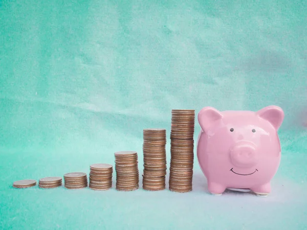 Banco piggy rosa com pilha de moedas, economizando dinheiro para o futuro plano e conceito de fundo de aposentadoria — Fotografia de Stock