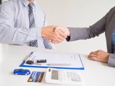 Müşteri kadın kredi kartı kullanılan ve kiralık araba formu satıcı için imzalanan, Shake el ele anlaşma iş