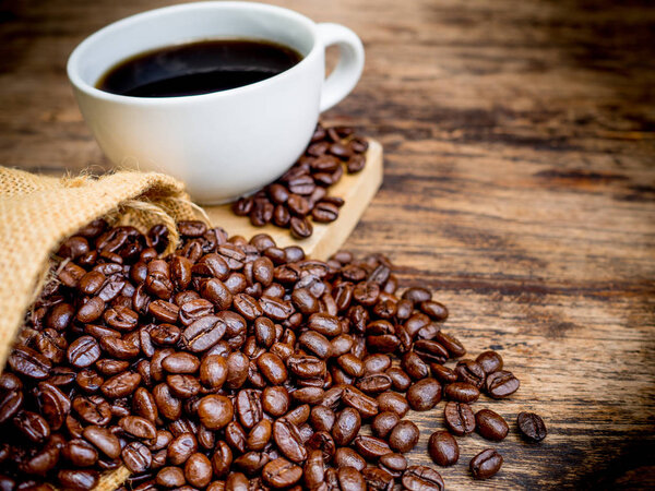 Coffee beans are spilling from the bag, ready to give freshness and alongside the businessman