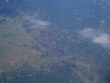 Mavi gökyüzü ve yüksek açılı zemin olan uçak penceresinden bulutlar