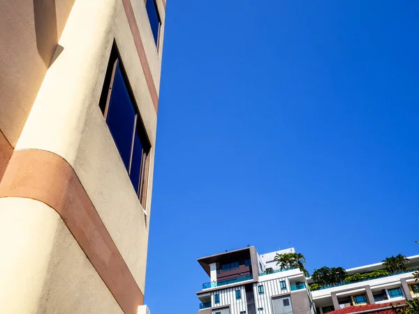 Photo of blue sky and clouds between the buildings.