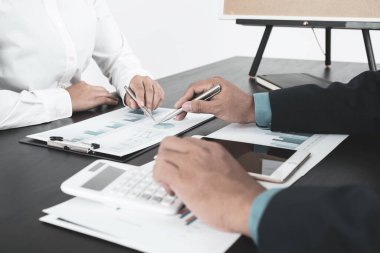 İş adamları ve iş kadınları ekibi, iş gelirlerini artırmak için strateji planlama toplantılarına işaret ediyor. Beyin fırtınası grafiği analizi yapın ve yeni hedefin başarısını tartışın..
