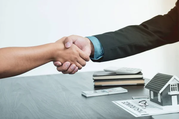 Real estate agents and buyers handshake after signing a business contract, renting, buying, mortgage, loan or home insurance.