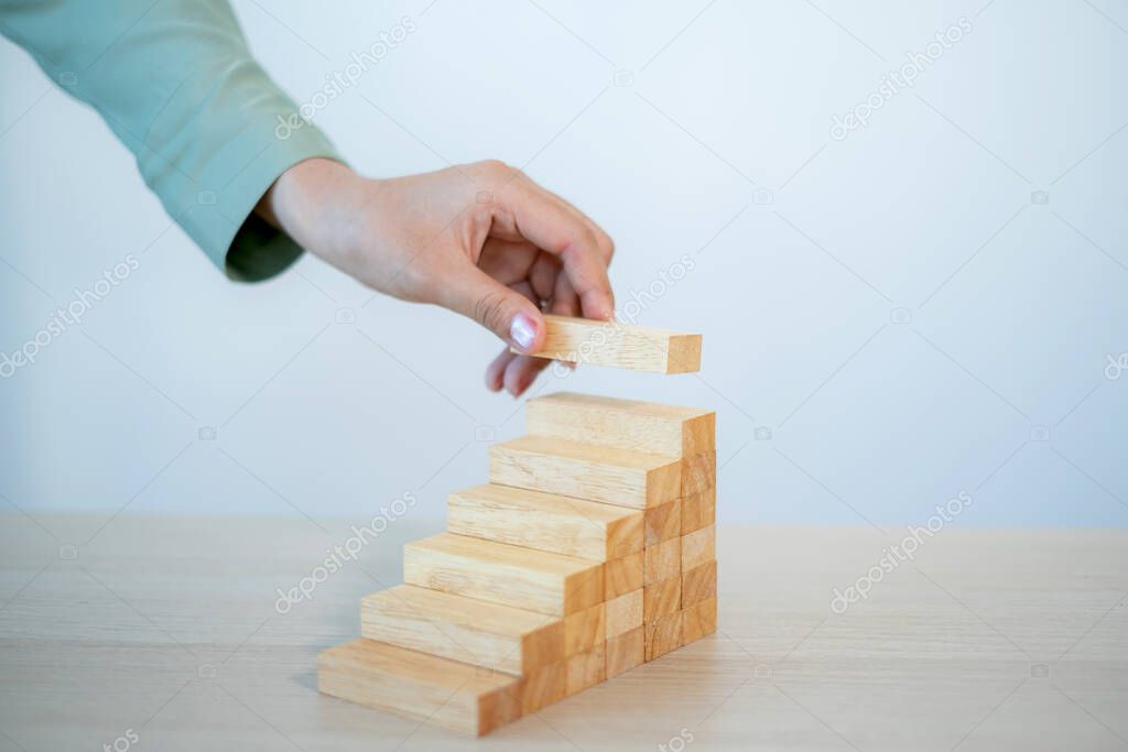 Businesswoman hand holding blocks wood game, Concept Risk of management and strategy plan, growth business success process and team work.