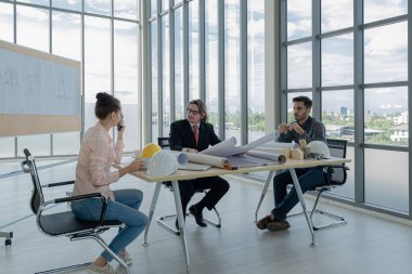 Mühendisler inşaat çizimlerini incelemek, plan yapmak ve inşaata başlamadan önce işleri dağıtmak için toplanıyorlar..