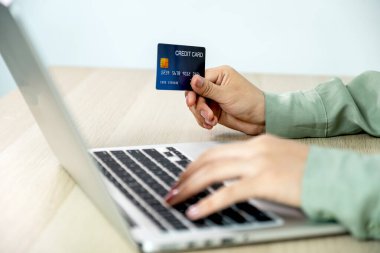 İş kadını el ele tutuşması ve kredi kartıyla evden bilgisayarla alışveriş, ödeme e-ticaret, internet bankacılığı, gelecek tatiller için para harcamak.