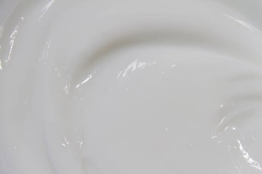 Krem losyonunun beyaz yüzeyi arka planı yumuşatır.