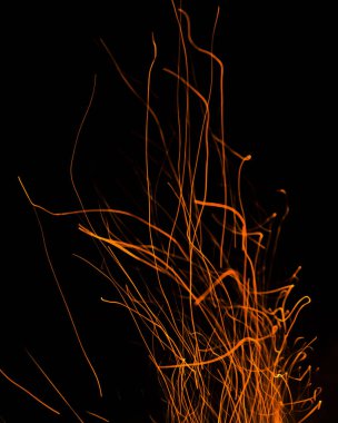 Siyah arkaplanda kıvılcımlar saçan ateş alevleri