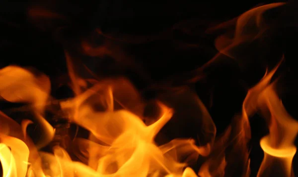 FireHot flame on a black background — Stock Photo, Image