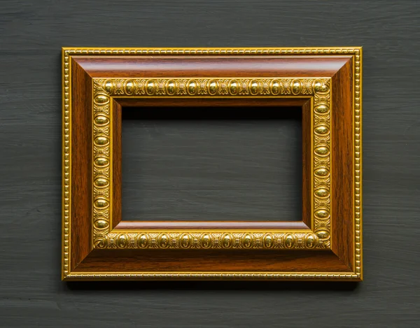 Frame goud geplaatst op een houten vloer. — Stockfoto