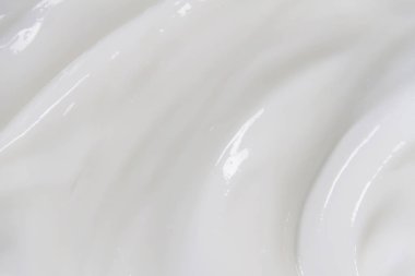 Krem losyonunun beyaz yüzeyi arka planı yumuşatır.