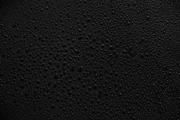 Gotas de água sobre fundo preto e textura. — Fotografia de Stock