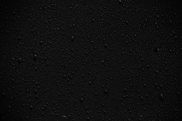 Gotas de água sobre fundo preto e textura. — Fotografia de Stock