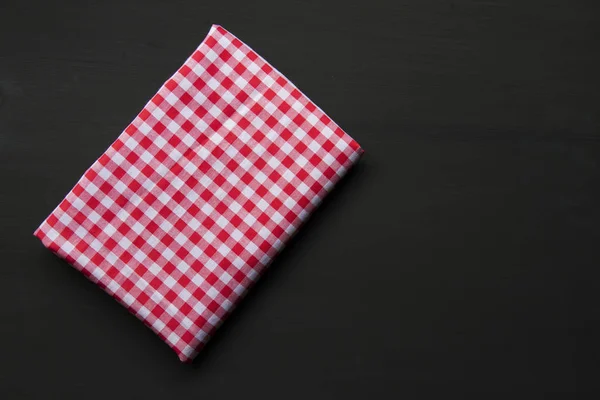 Checkered napkin on wooden background — Stock Photo, Image