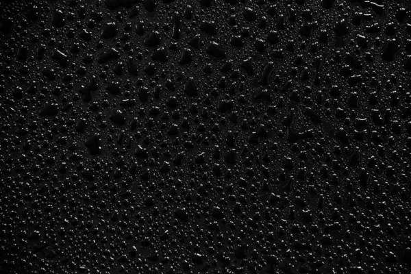 Waterdruppels op zwarte achtergrond en textuur. — Stockfoto
