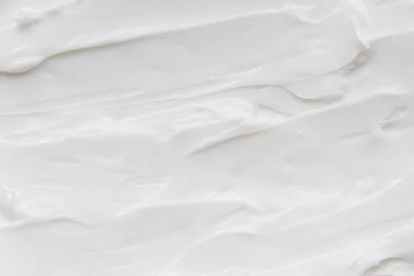 พื้นหลังสีขาวของโลชั่นครีม — ภาพถ่ายสต็อก