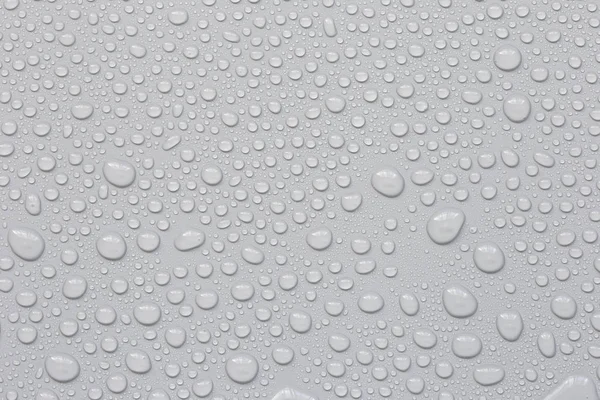 Wassertropfen auf grauem Hintergrund — Stockfoto