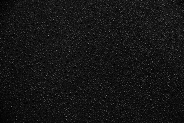 Gotas de agua sobre fondo negro y textura. — Foto de Stock