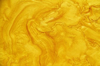 Altın akrilik arka plan dokusunun yakın çekim.