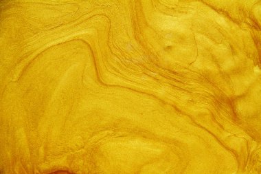 Altın akrilik arka plan dokusunun yakın çekim.