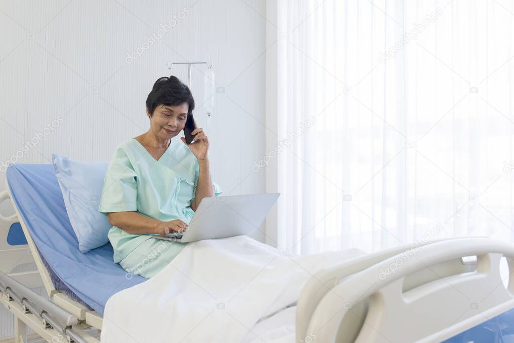 The elderly Asian women sit in bed, recover, talk on the phone, and do errands on laptops, in hospitals, special rooms.