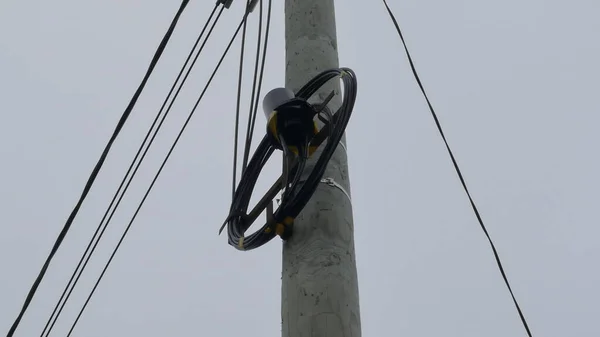 an Internet cable hangs from a pole