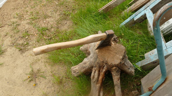 the axe is stuck in an old stump
