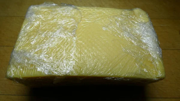a piece of cheese in cellophane packaging