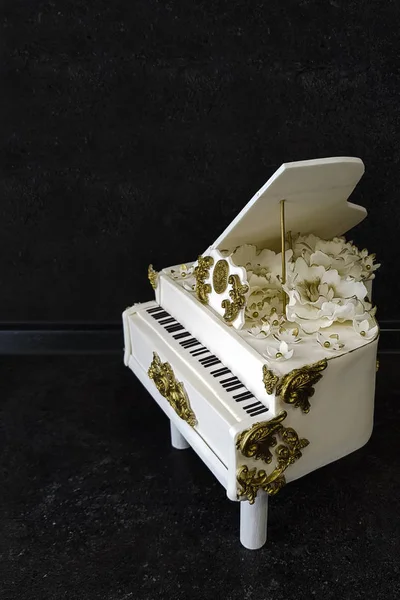 The handmade cake in the shape of a white piano