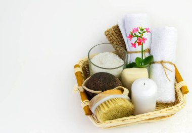 Beyaz arka planda havlular, sünger taşları, tuz ve mum ile spa tedavileri için hazır..