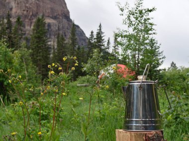 Morning Coffee While Camping in the Mountains clipart