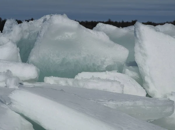 Thick slabs of frozen ice broken and piled on shore of the Ottawa River — Stock Photo, Image