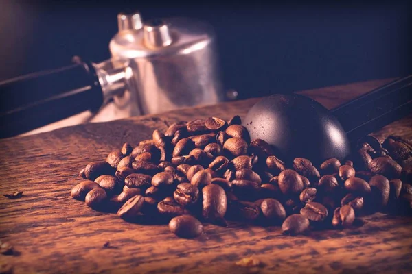 coffee beans and accessories on textured wooden background