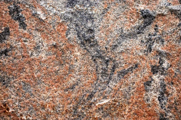 texture of red granite stone with black splashes