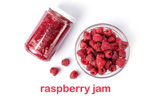 Raspberry jam in glass with metal spoon isolated on white