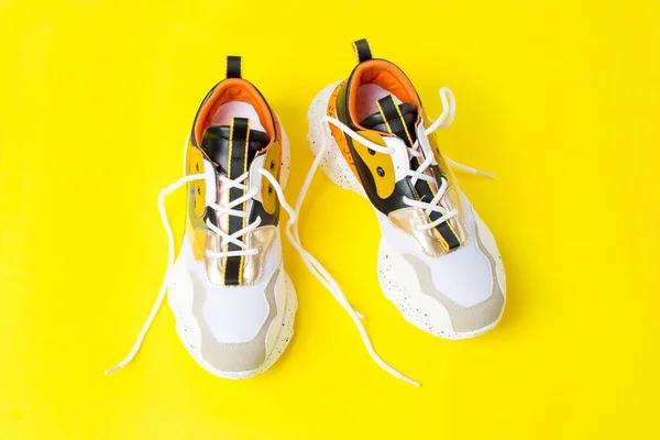 autumn sports shoes on a yellow background, autumn sneakers