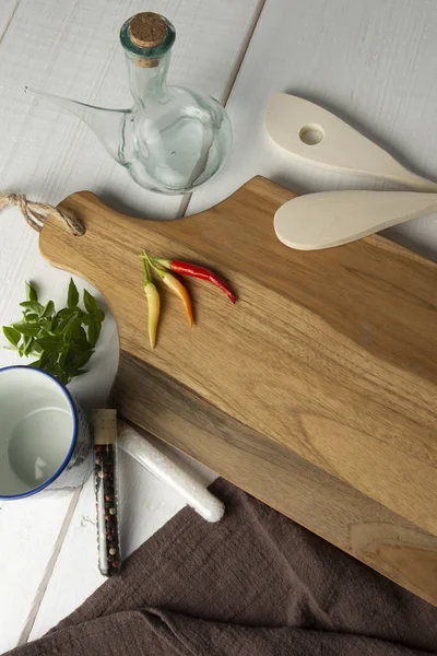 Red Chili Peppers, orange and yellow on wooden cutting board. — Stock Photo, Image