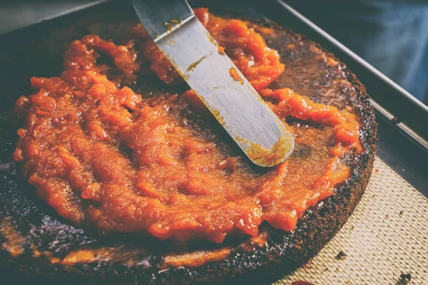 Preparation of cake, spreading of jam on cakes