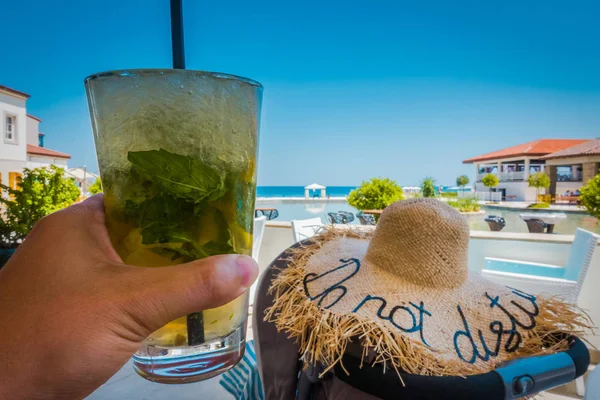 Mojito cocktail on a table on a sea background