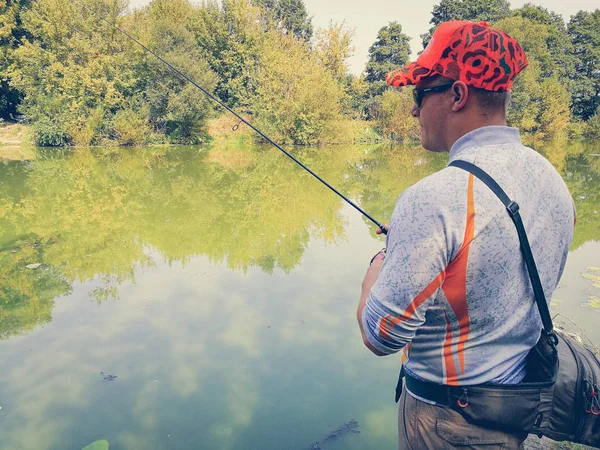 Young man fishing. bokeh , blurred background — Stock Photo, Image