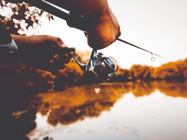 Young man fishing. bokeh , blurred background