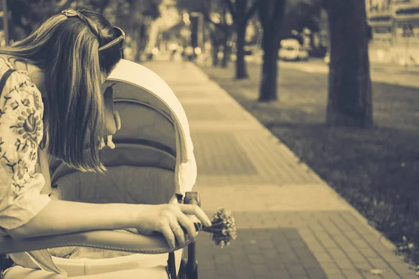 Mother over a stroller — Stock Photo, Image