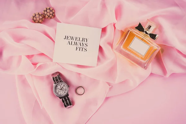 Various makeup products on pink background