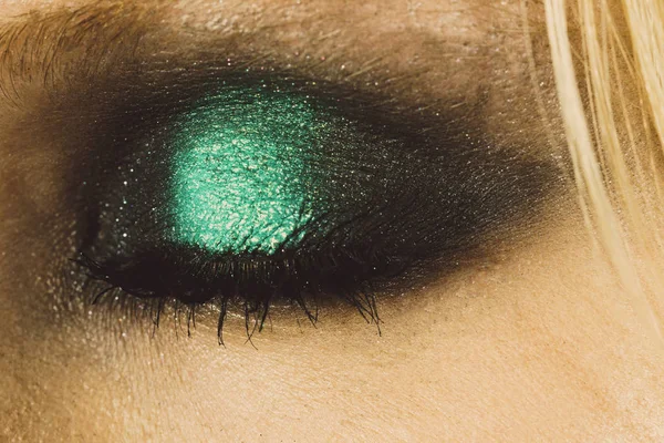 Eye makeup with green shadows